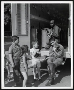 Senior keeper Roy Smith holding pup on traveling zoo